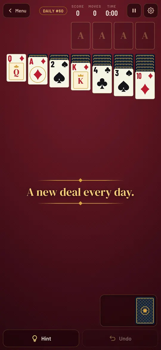 Paydirt Solitaire on a phone: cream cards on a claret table.
